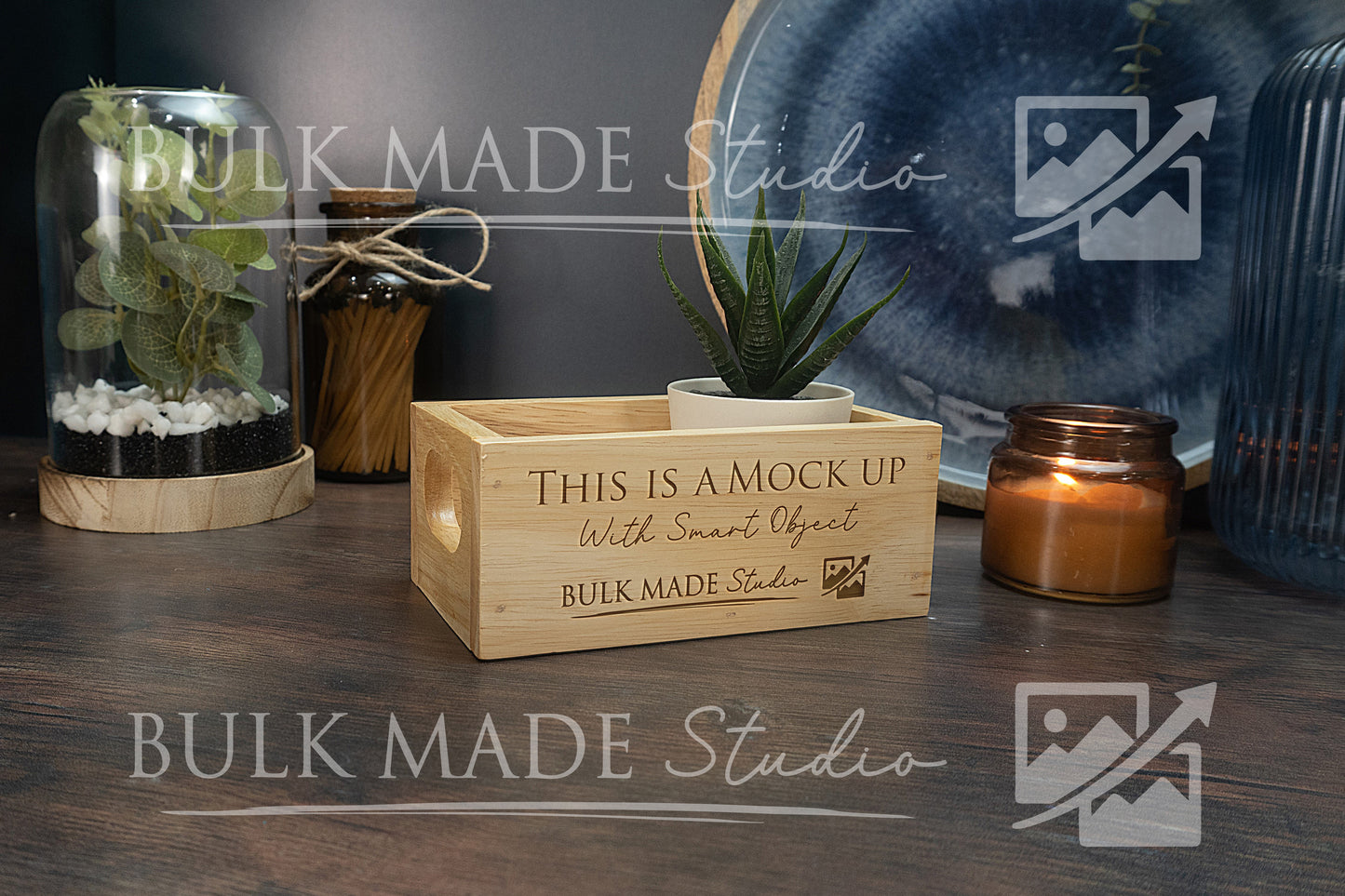 Wooden crate with 'This is a mock up' text on a wooden surface with decorative items.
