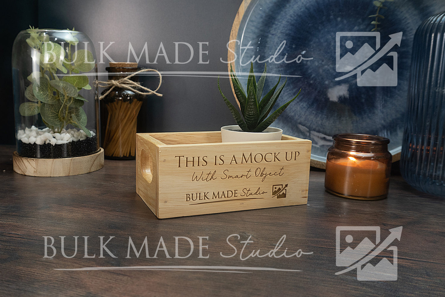 Wooden crate with 'This is a mock up' text on a wooden surface with decorative items.