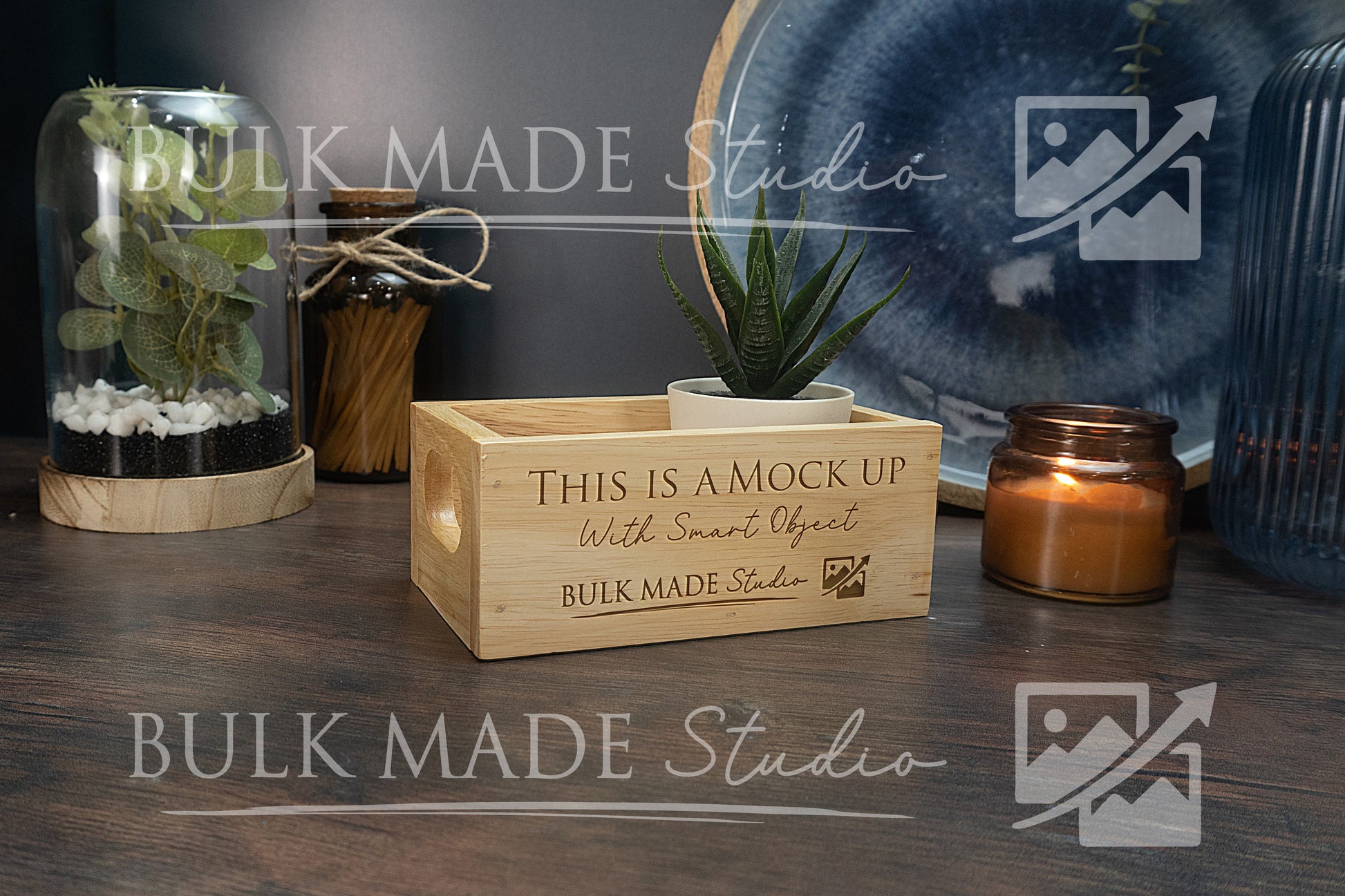 Wooden crate with 'This is a mock up' text on a wooden surface with decorative items.