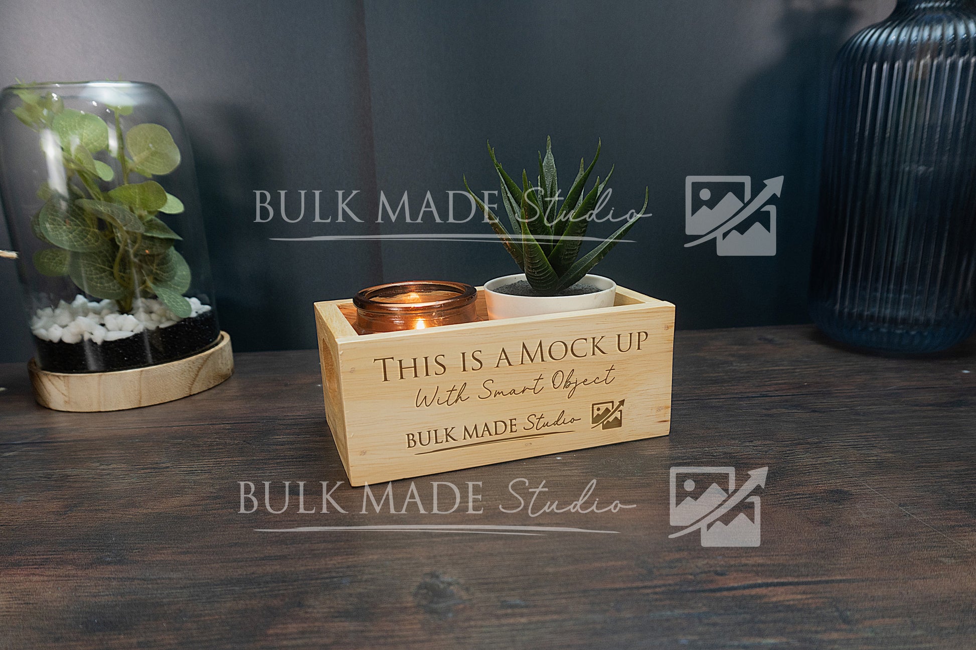 Wooden box with plants and a pot on a wooden surface, branded 'Bulk Made Studio'.